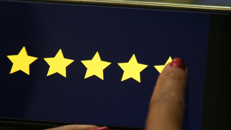 Manager giving five star rating on smartphone