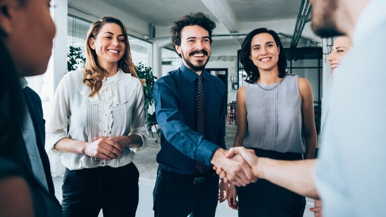  handshaking between business people